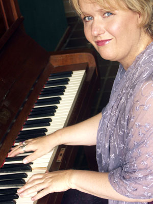 Pamela playing piano looking to left